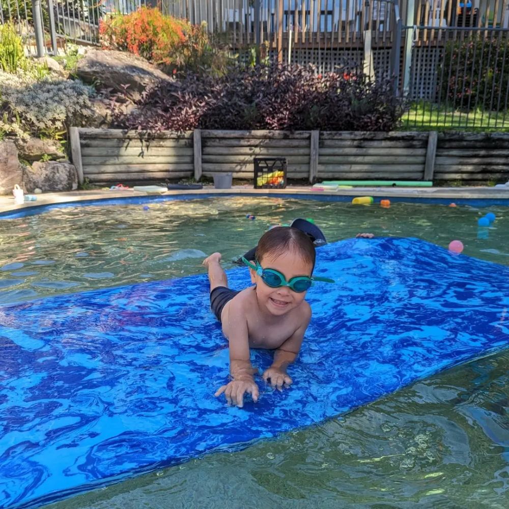 Toddler crawling on a floating mat